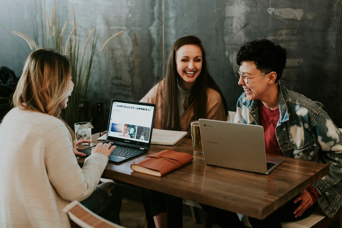 Three people in warm conversation around a table