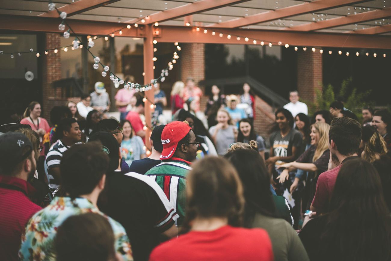 A community gathering beneath warm string lights