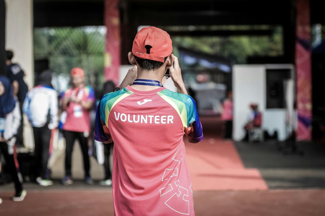 A volunteer in a bright vest at a community event